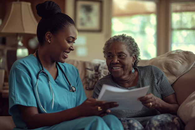 A caregiver reviewing a care plan with an older woman on her sofa